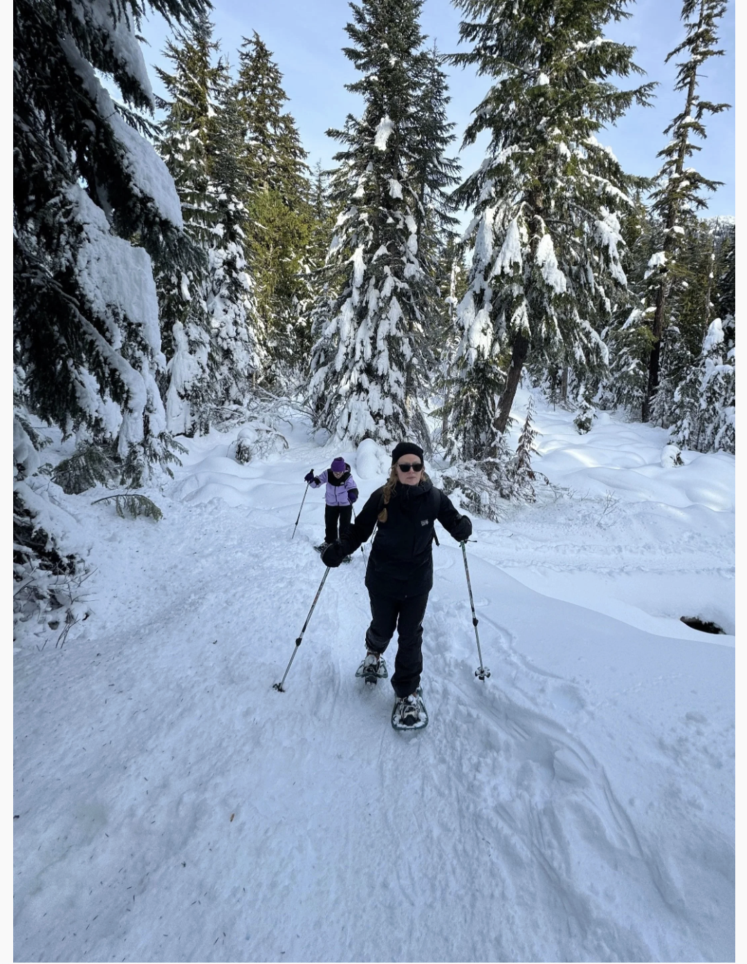 Merriah snowshoeing on a forest trail